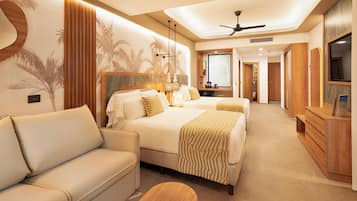 A hotel room with a bed, a sofa, a TV, and a ceiling fan.