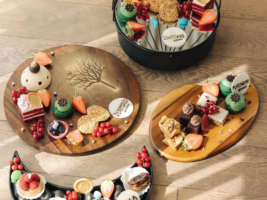 A variety of desserts on wooden trays.