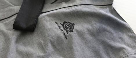 A grey hotel garment with a black strap and a logo that reads "HOTELRESORTS".