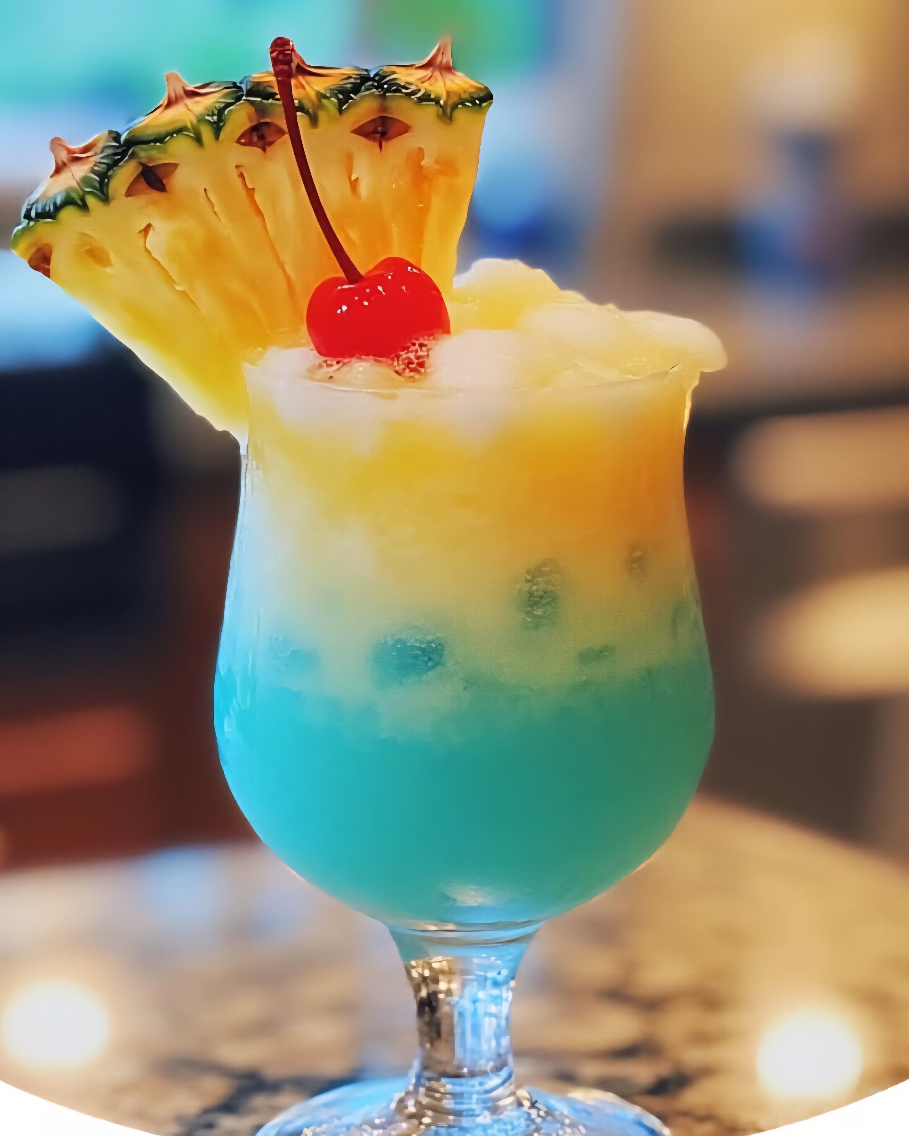 A cocktail in a glass with a pineapple garnish and a cherry on top.