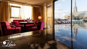 A hotel room with a view of a cathedral and a modern building.