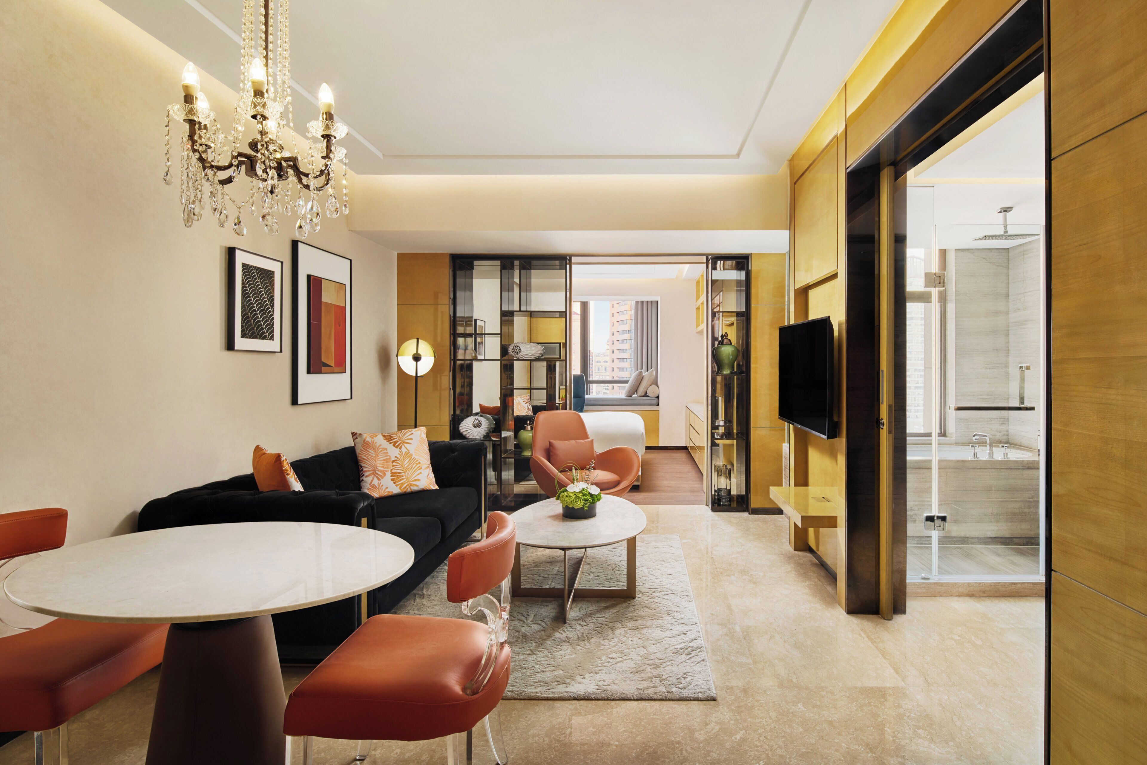A modern living room with a sofa, chairs, a coffee table, and artwork on the walls.