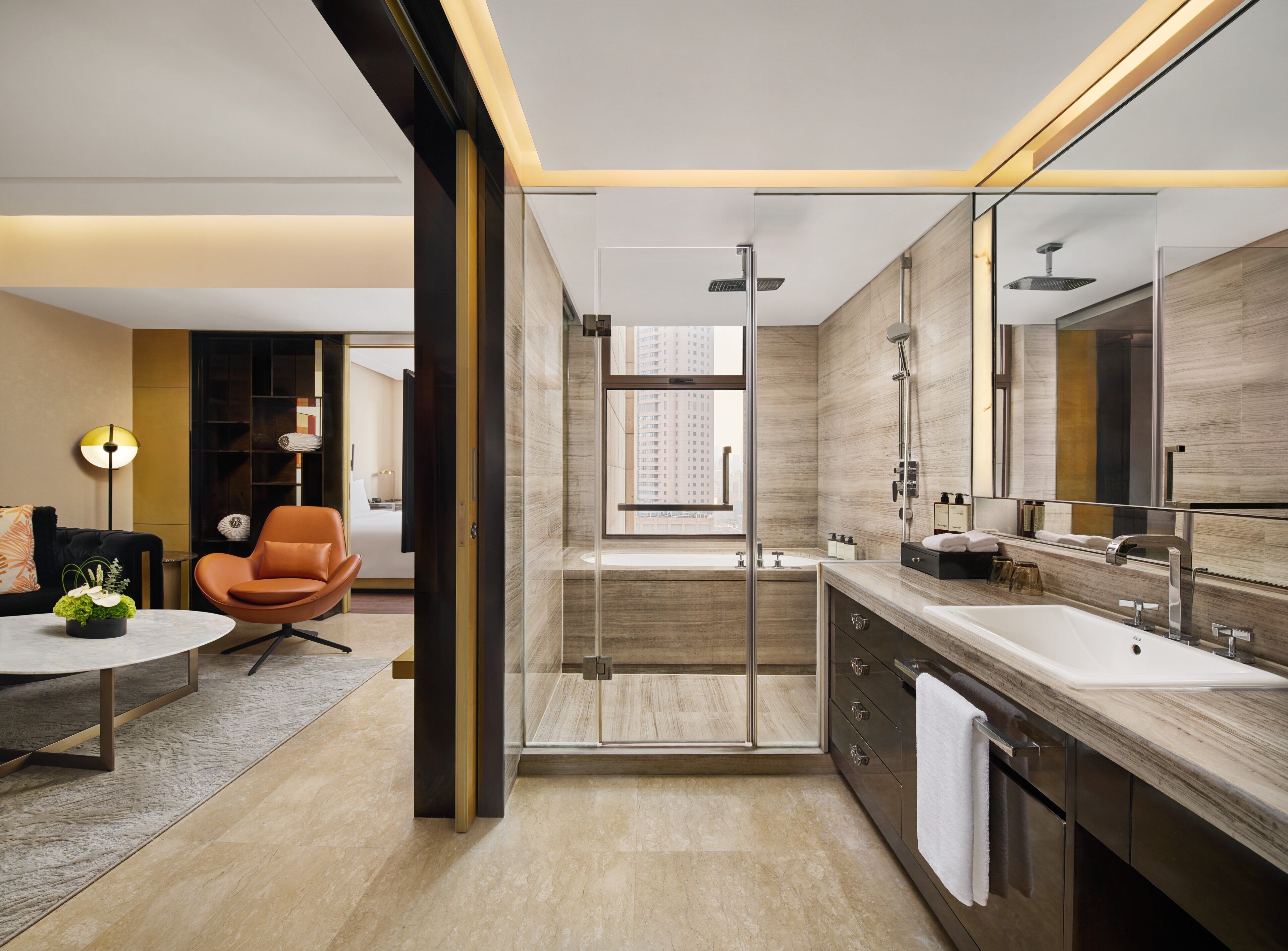 A modern bathroom with a glass shower enclosure, a large mirror, and a vanity with a sink.