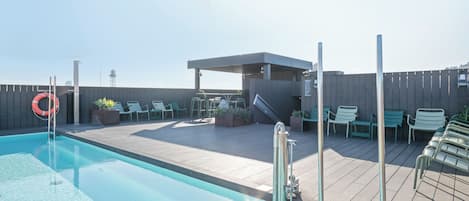 Outdoor pool, open 9:00 AM to 9:00 PM, pool loungers