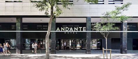 A modern hotel entrance with a prominent sign reading "ANDANTE HOTEL".