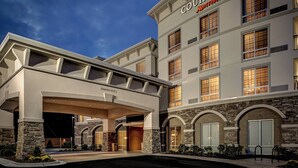 A Courtyard Marriott hotel with a covered entrance, stone facade, and multiple windows. - Courtyard Boone (Boone)