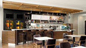 A modern bar area with a counter, seating, and menu boards. - Courtyard Boone (Boone)