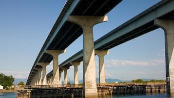 A large concrete bridge with multiple arches spanning over a body of water.
