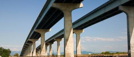A large concrete bridge with multiple arches spanning over a body of water.