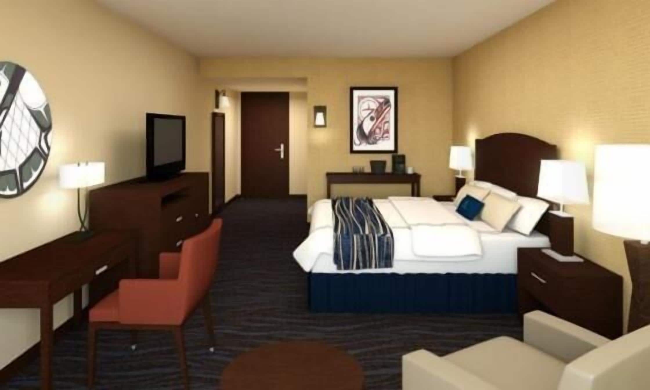 A hotel room with a bed, a desk, a chair, a television, and a painting on the wall.