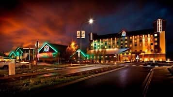 A hotel with a modern design, featuring a prominent Q logo on the facade.