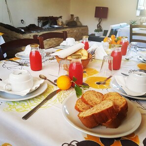 Enjoy a delicious breakfast with a variety of options, including fresh bread, lemons, and juice.