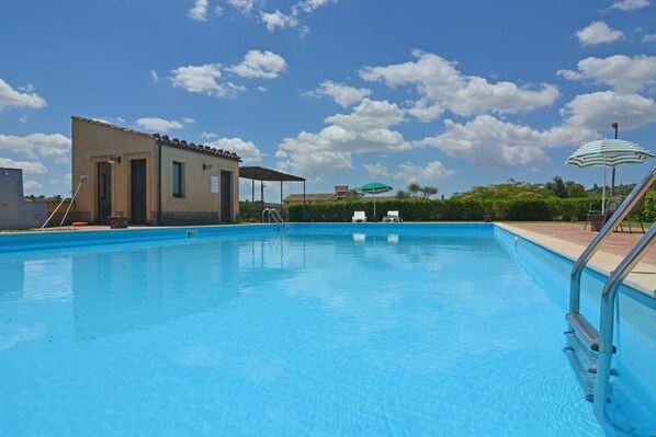 Seasonal outdoor pool, open 9:30 AM to 6:30 PM, pool umbrellas