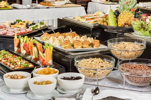 A buffet with various food items including fruits, vegetables, sandwiches, and cereals. - ALFAVITO Kyiv Hotel (Kyiv)