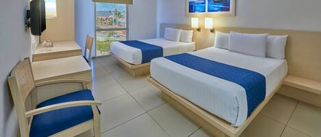 A hotel room with two beds, a desk, a chair, and a TV.