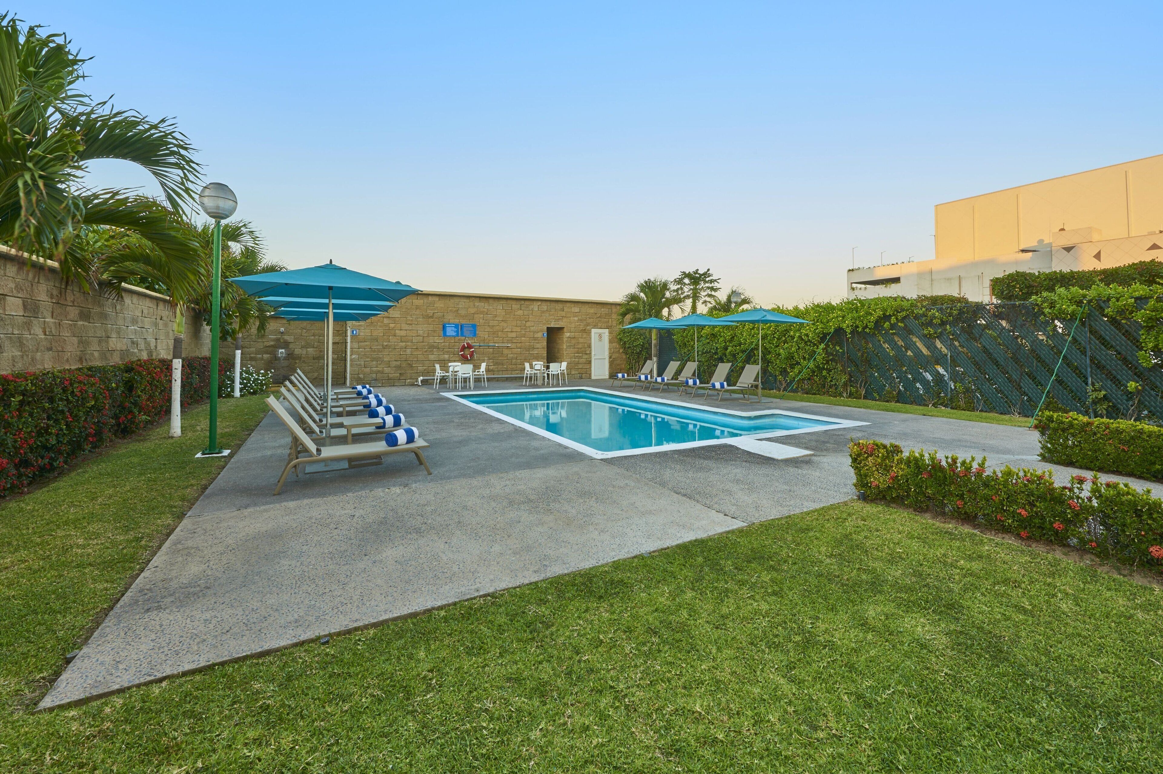 outdoor pool, open 8:00 am to 8:00 pm, pool umbrellas, pool loungers