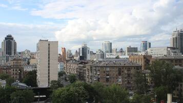 A cityscape with a mix of high-rise and low-rise buildings, including a prominent tower and several residential buildings.