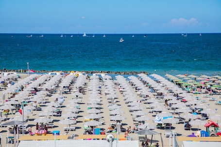 On the beach, sun-loungers, beach umbrellas. Hotel Gabbiano