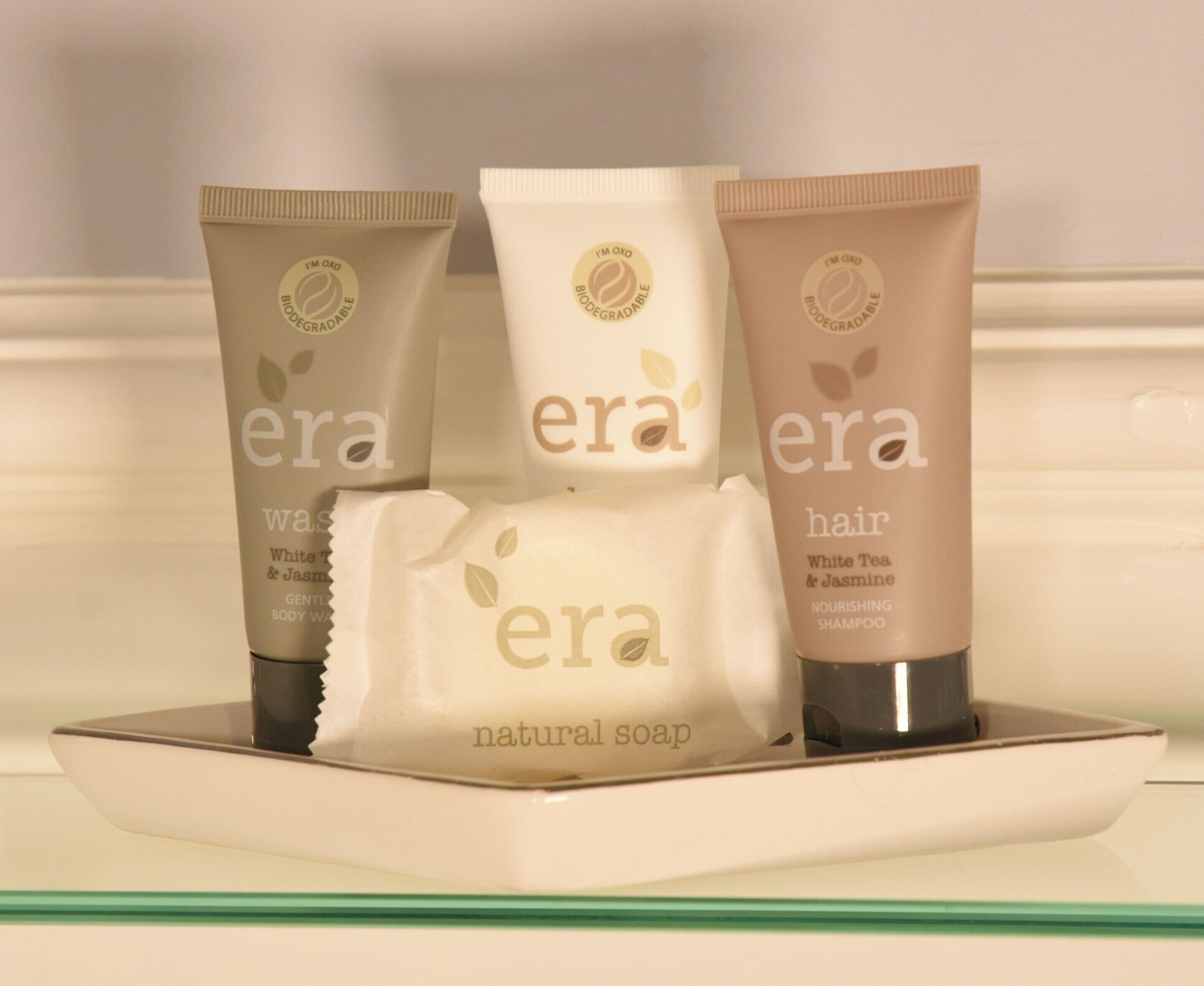Three bottles of era hair shampoo and one bottle of era natural soap.