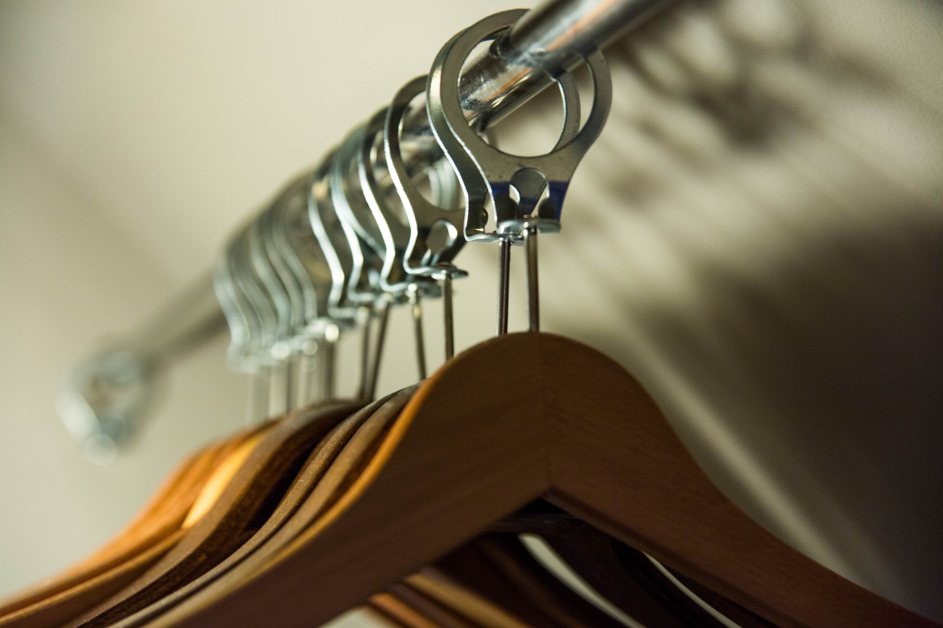 A metal rack with wooden hangers.