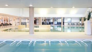Relax by the pool in a clean and well-maintained space with a rectangular pool and comfortable lounge seating.