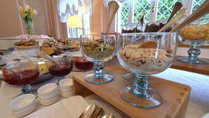 A buffet table with various food items and serving utensils. - Settentrionale Esplanade (Montecatini Terme)