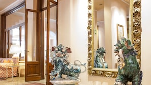 A lobby with ornate decor, including a large mirror and two animal statues. - Settentrionale Esplanade (Montecatini Terme)