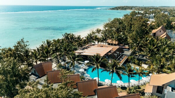 A resort with a pool, beach, and ocean view.