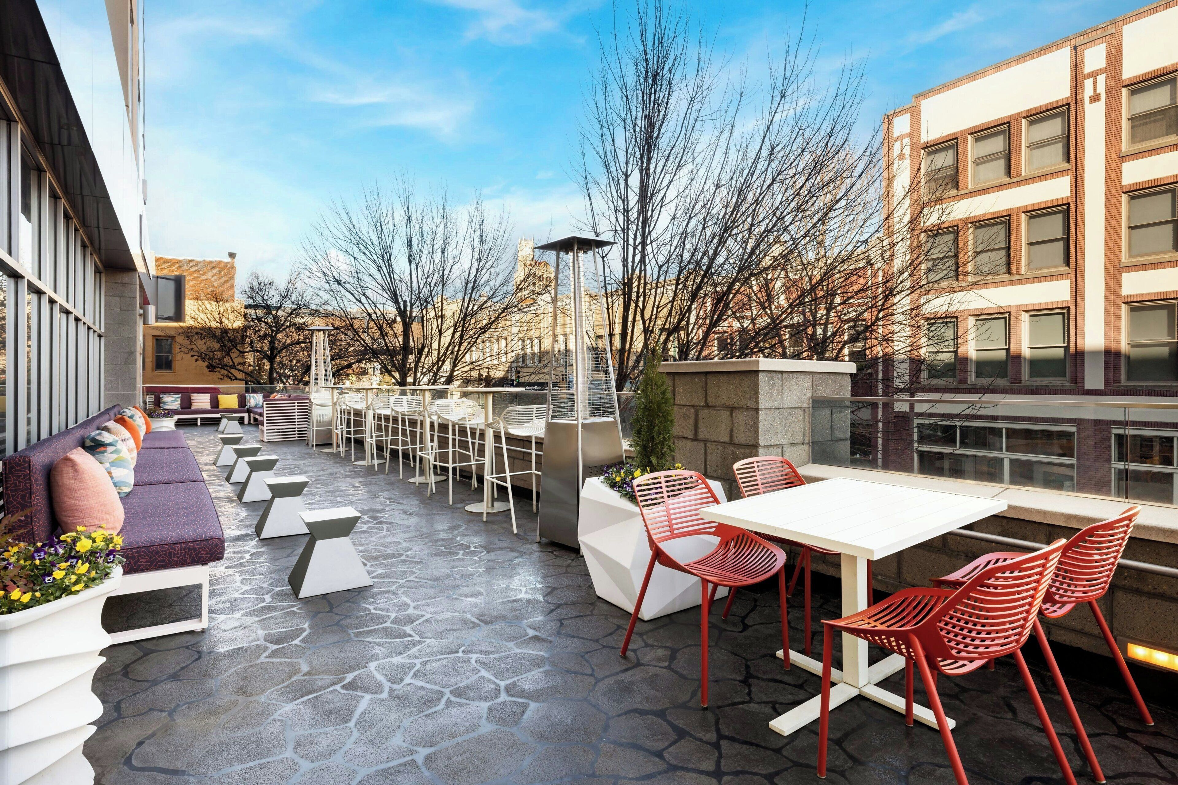 An outdoor patio with seating, tables, and chairs.