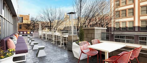 An outdoor patio with seating, tables, and chairs.