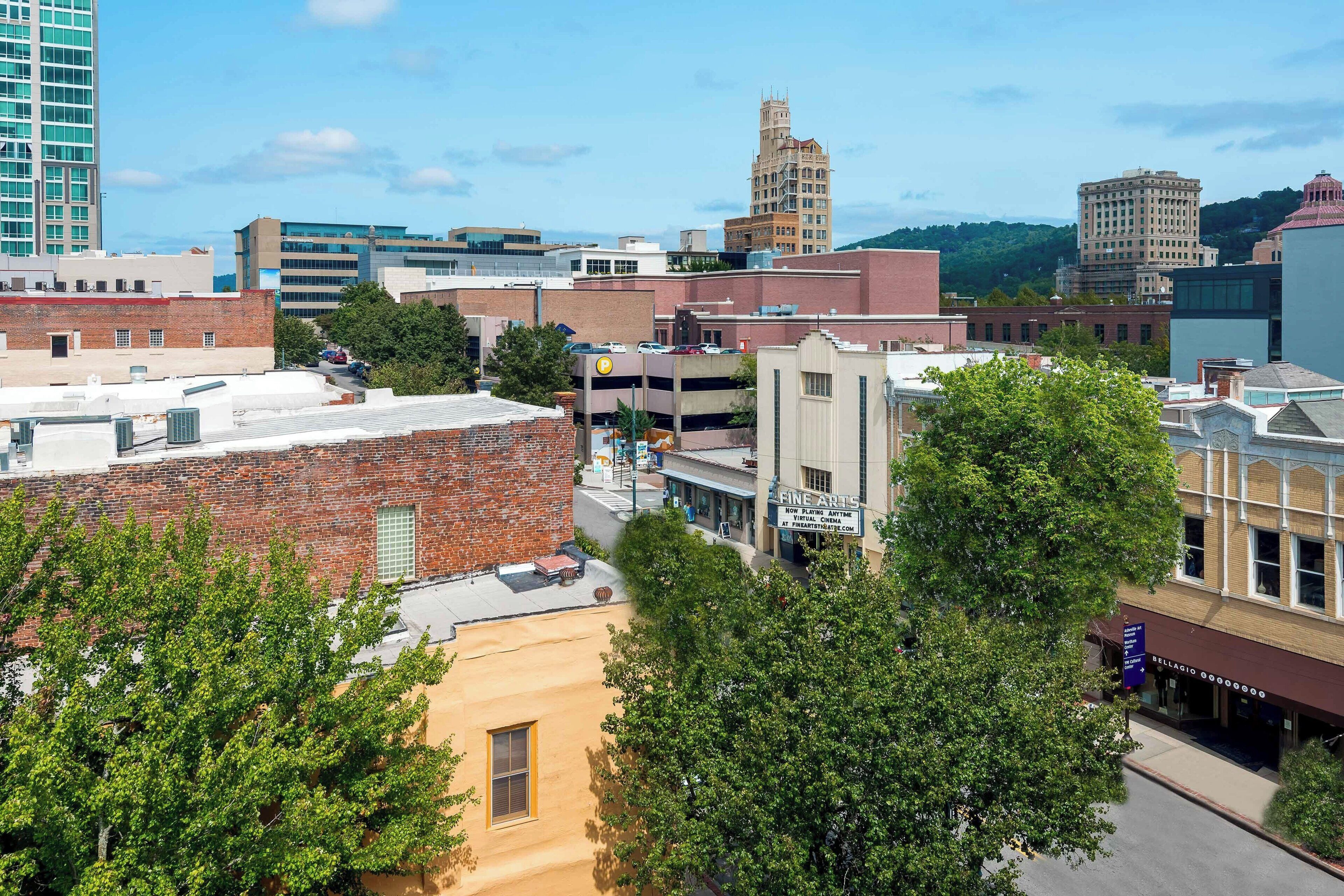 A downtown area with various buildings, including a hotel with a sign that reads "Fine Arts."