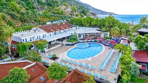 Ein Resort mit Pool, Außenbereich und Meerblick.
