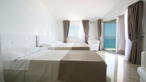 A hotel room with two beds, a chair, and a balcony with curtains. - Resort Hotel Rocca di Vadaro (Ricadi)