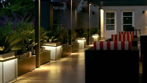 An outdoor patio area with planters, a seating area, and a door.