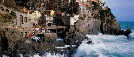 A coastal town with buildings built on a cliff overlooking the sea.