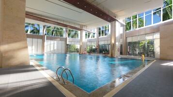 Swimmers can enjoy a refreshing dip in the rectangular pool surrounded by a tiled floor and accessible via two ladders.
