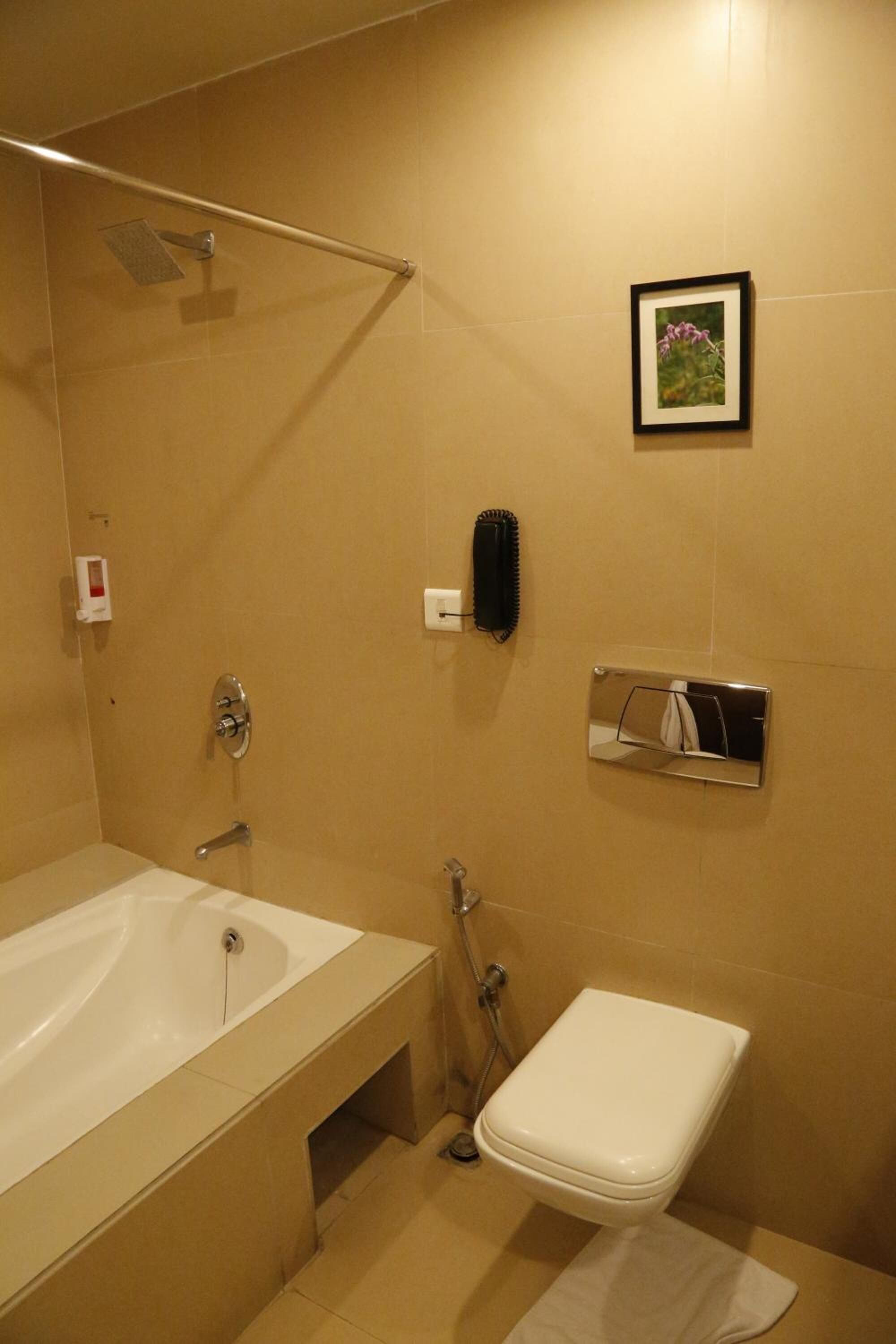 A bathroom with a bathtub, toilet, and a shower.
