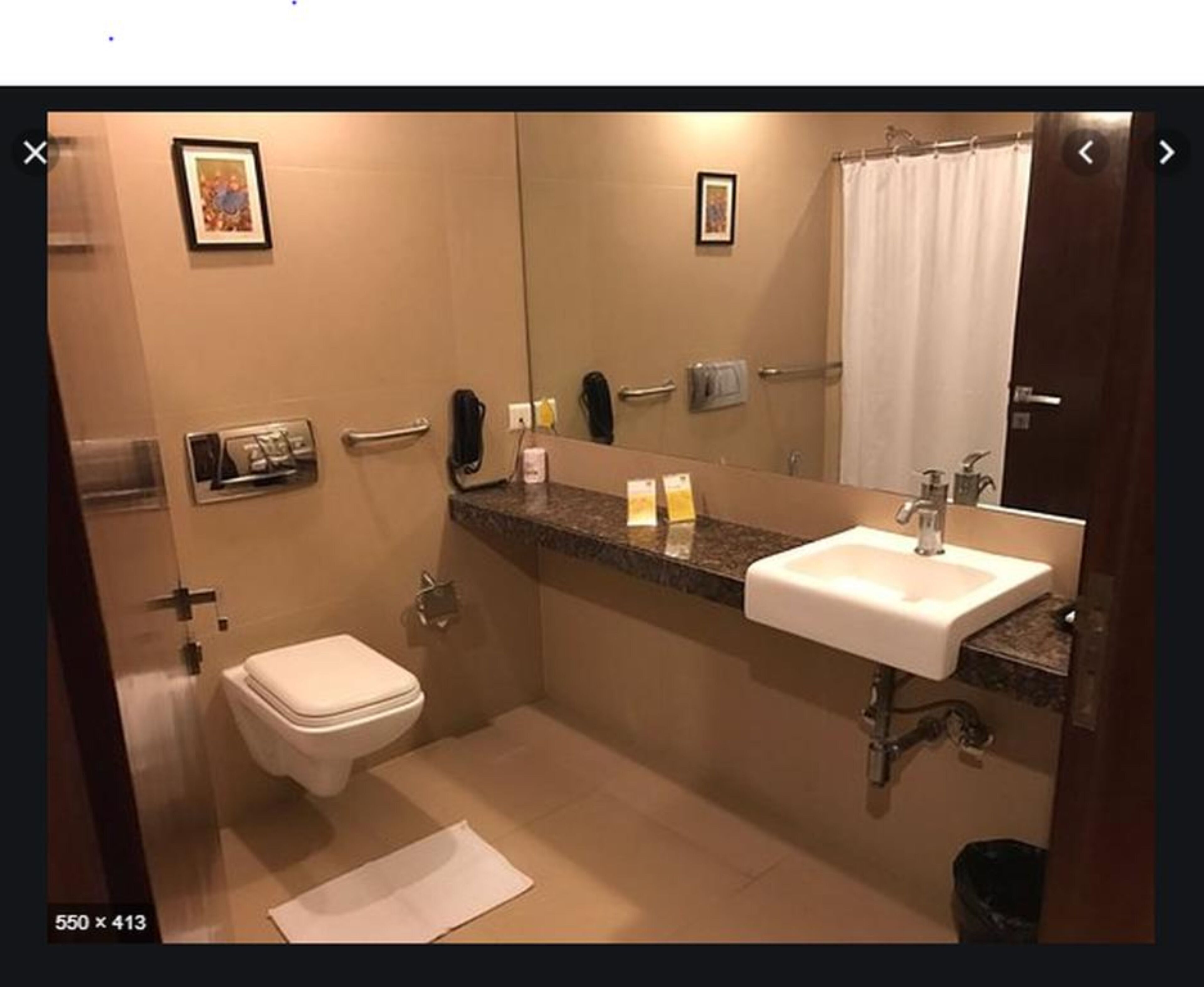 A bathroom with a toilet, sink, and shower.
