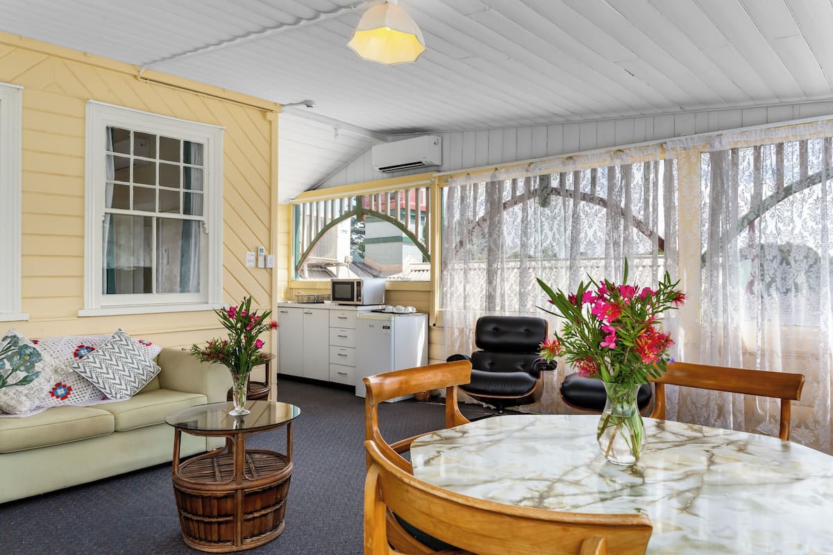 Premium Quadruple Room | Living area | 30-inch TV with digital channels