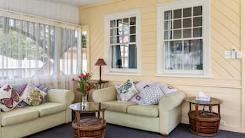 Premium Quadruple Room | Living area | 30-inch TV with digital channels