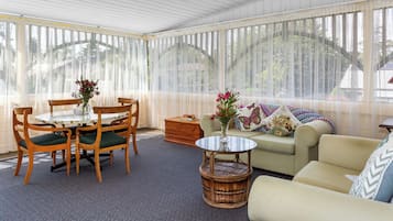 Premium Quadruple Room | Living area | 30-inch TV with digital channels