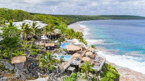 A resort with a pool, lounge areas, and a view of the ocean. - Scenic Matavai Resort Niue (Tamakautoga)