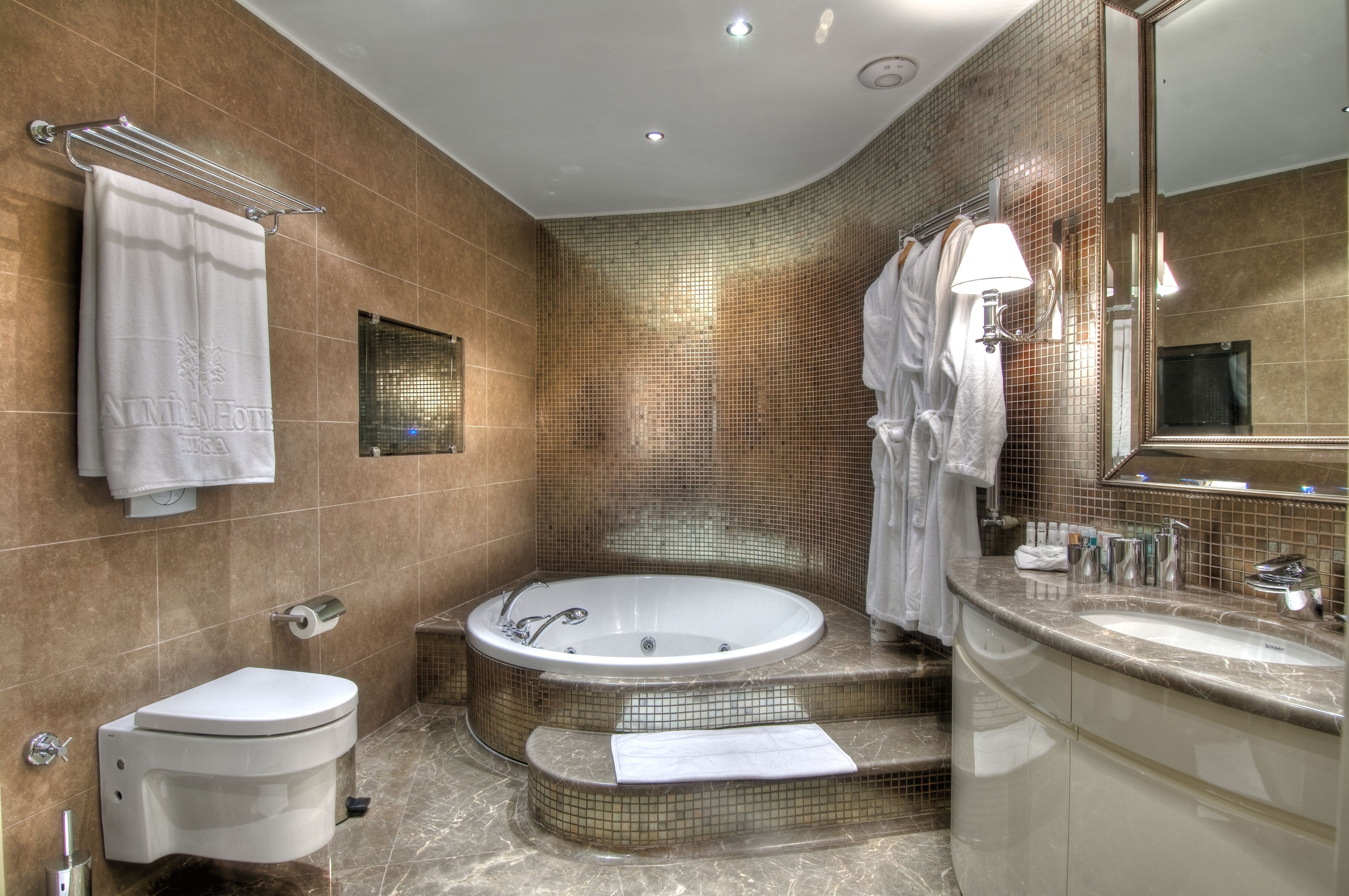 A modern bathroom with a bathtub, toilet, and sink.