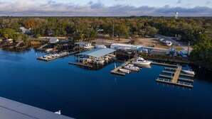 A marina with docks, boats, and a water tower in the background.