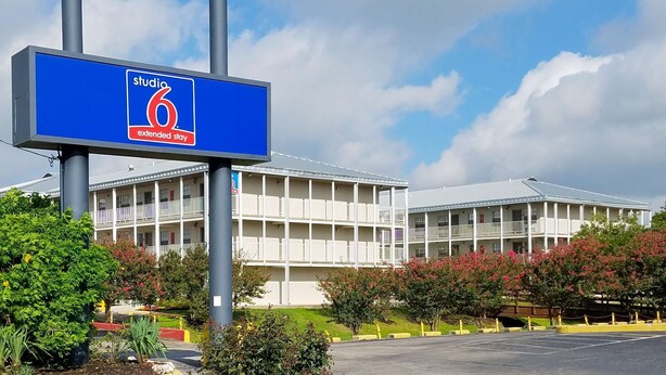 Un hôtel avec une enseigne indiquant « Studio 6, séjour prolongé ».