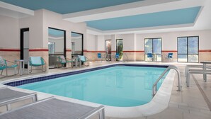 An indoor swimming pool with lounge chairs and a tiled floor. - TownePlace Suites Bridgeport Clarksburg (Clarksburg)