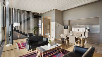 Suite, 1 King Bed (Duplex with Loft) | Living room | 42-inch LCD TV with cable channels, TV, pay movies