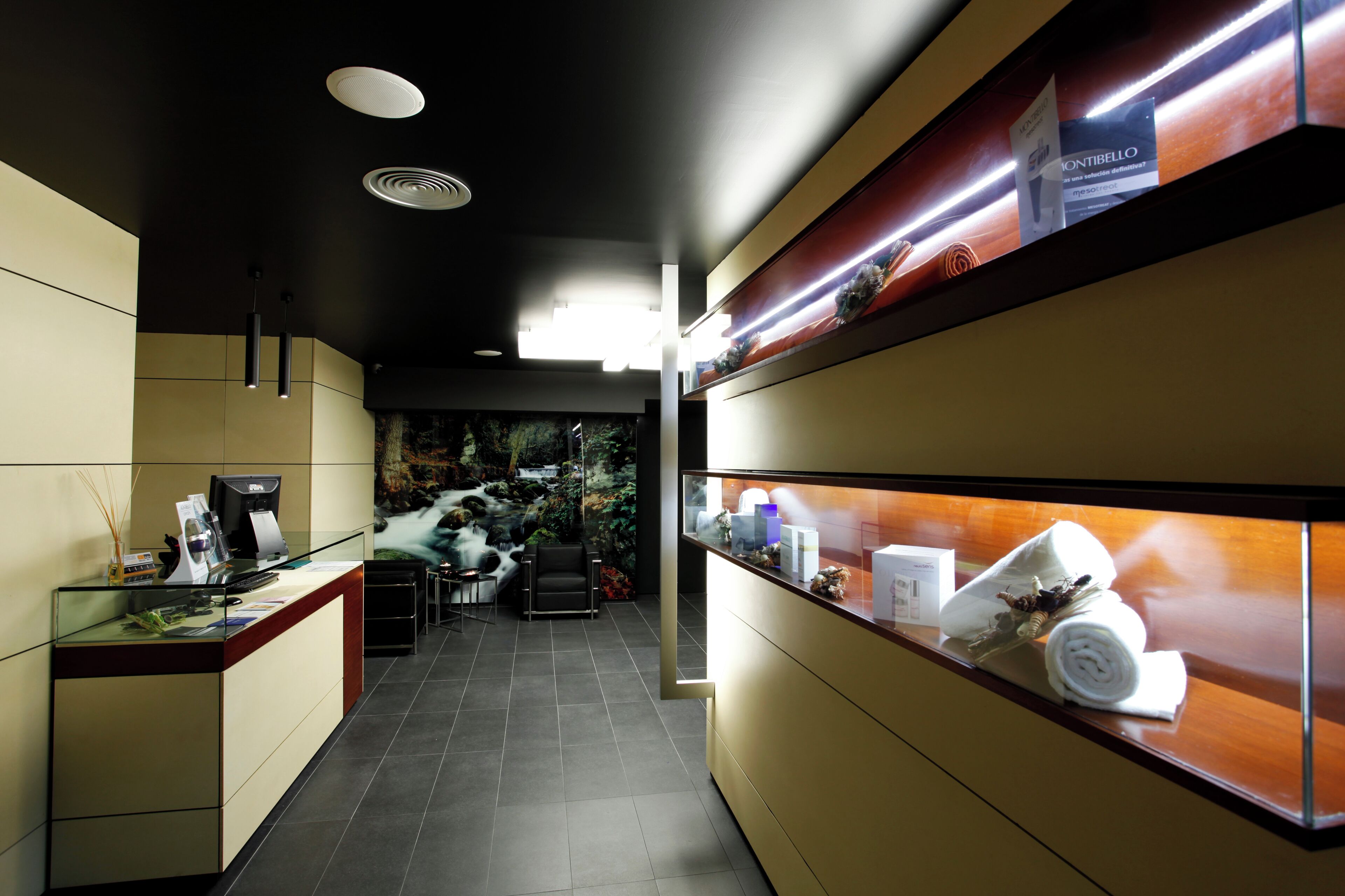 A reception area with a counter, a seating area, and a wall with a display case.
