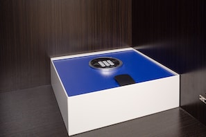 A blue and white safe with a keypad on a wooden surface.