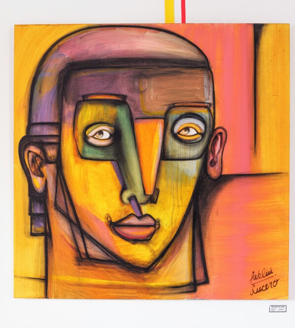 A painting with abstract human features and bold colors.
